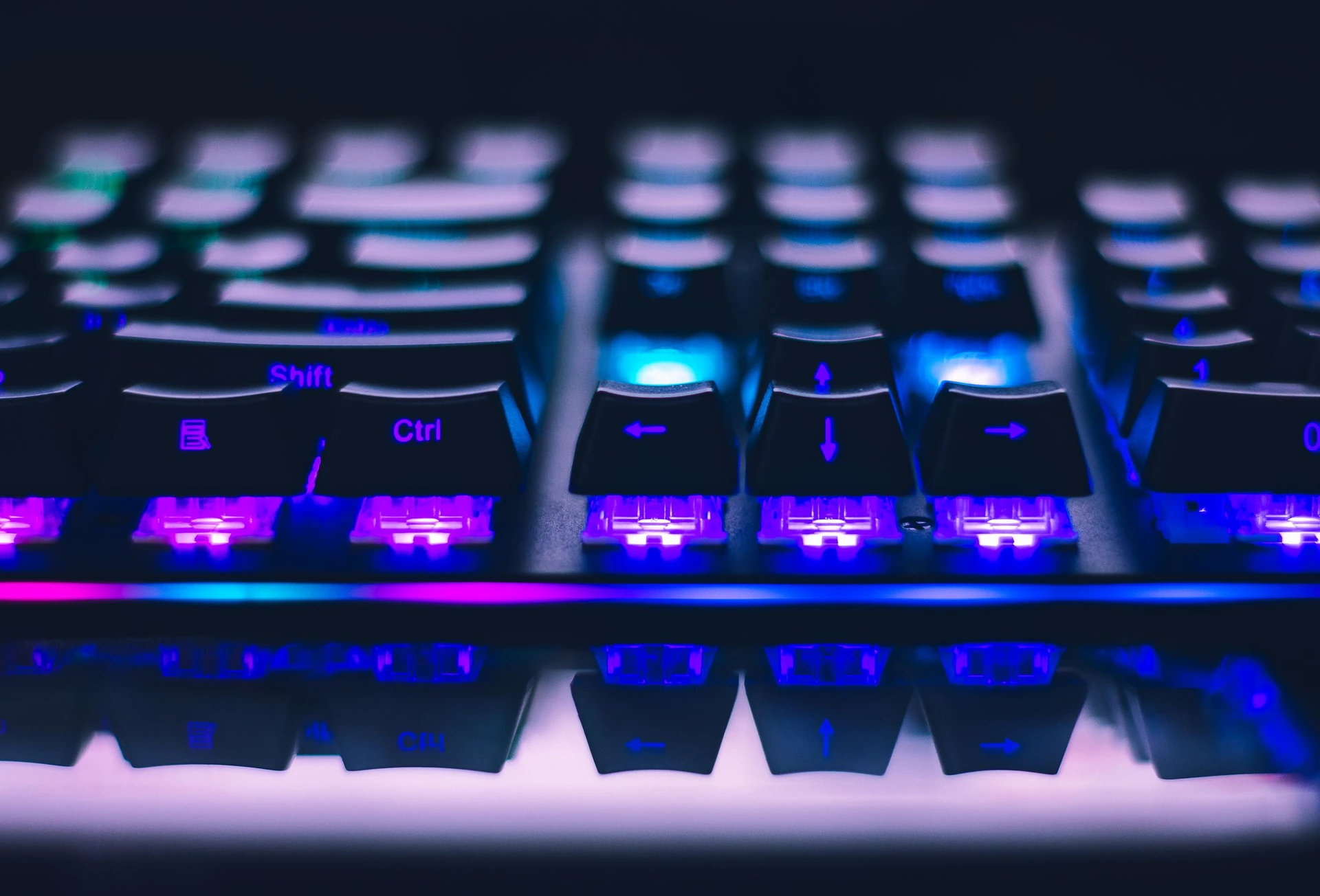 Close-up photograph of a backlit mechanical gaming keyboard