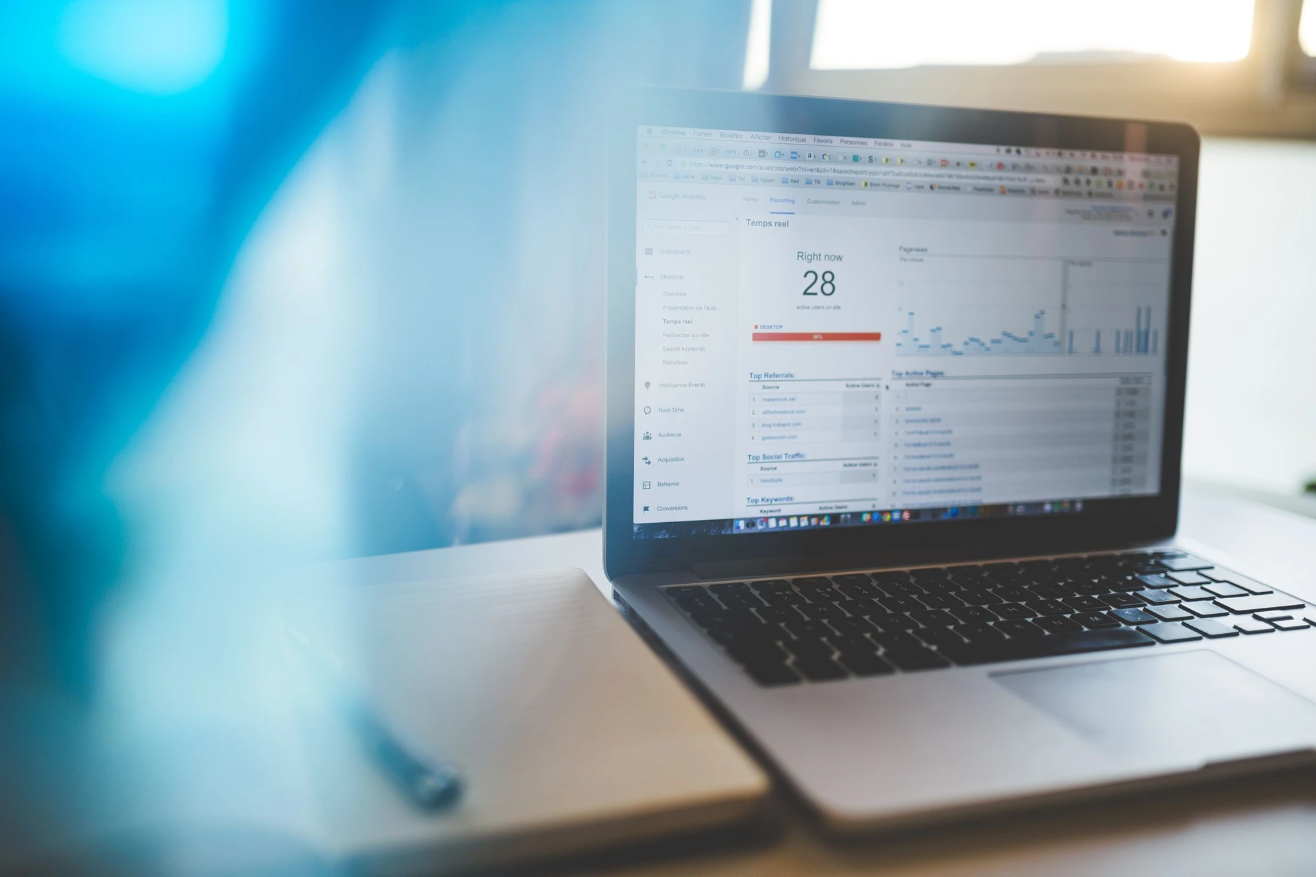 A laptop displaying a web analytics dashboard in a naturally lit workspace